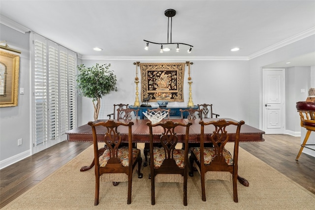 dining room with hardwood / wood-style floors and crown molding