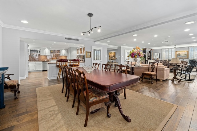 dining room featuring light wood-type flooring and ornamental molding