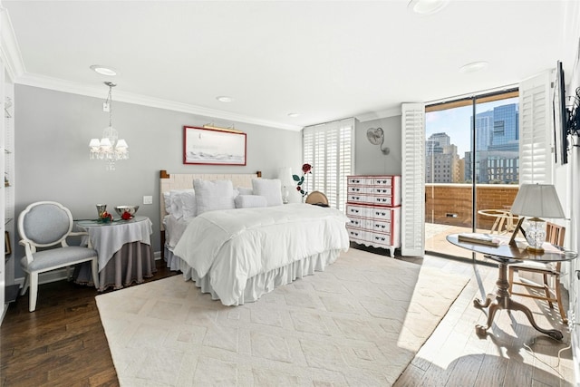 bedroom featuring wood-type flooring, crown molding, and a chandelier