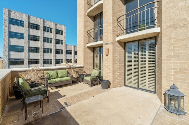 view of patio with a balcony and an outdoor hangout area