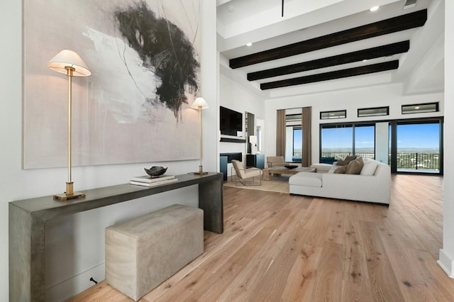 living room featuring light hardwood / wood-style floors and beamed ceiling