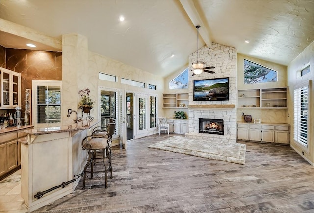 living room featuring high vaulted ceiling and wood-type flooring