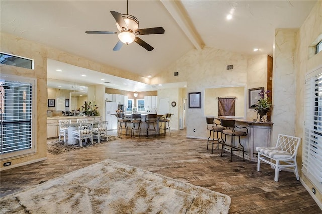 living room featuring beamed ceiling, dark hardwood / wood-style flooring, high vaulted ceiling, and ceiling fan