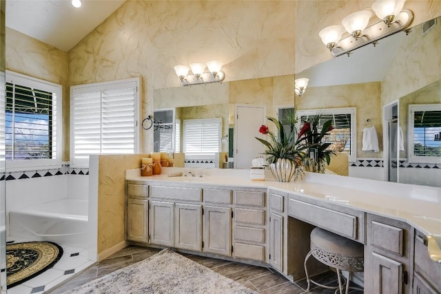 bathroom with vanity, hardwood / wood-style flooring, and a tub