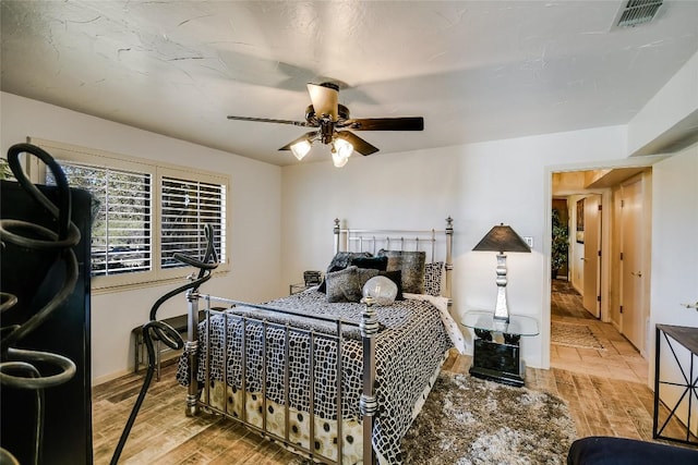 bedroom with hardwood / wood-style flooring and ceiling fan