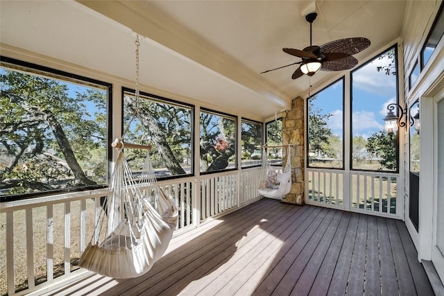 unfurnished sunroom featuring vaulted ceiling with beams and ceiling fan