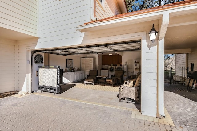 view of patio featuring washing machine and clothes dryer