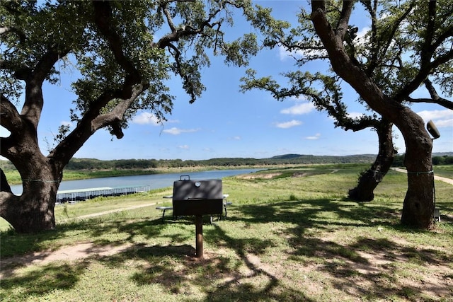 view of home's community featuring a water view and a yard