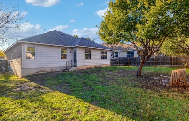 rear view of property with a yard and cooling unit