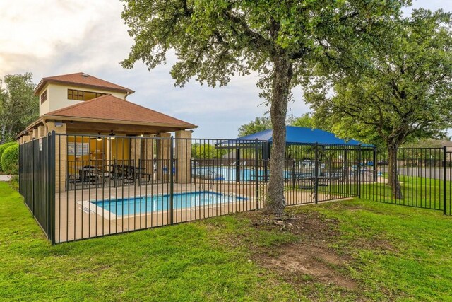 view of swimming pool featuring a yard and a patio area