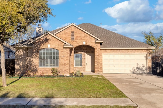 view of front of house with a front yard and a garage