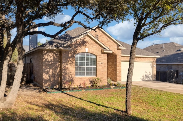 view of front of property with a garage and a front yard