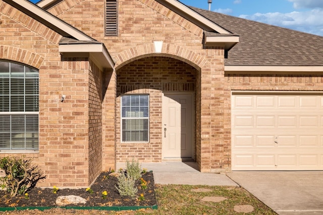 view of exterior entry with a garage