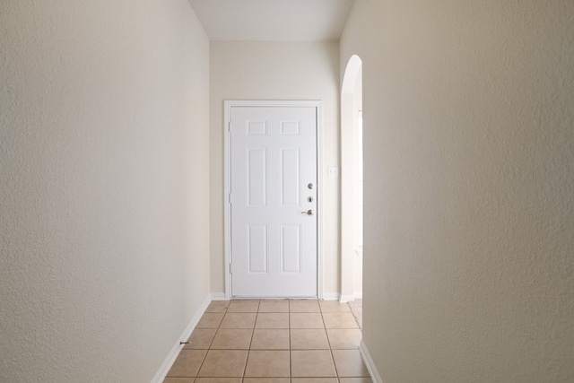 hall with light tile patterned floors