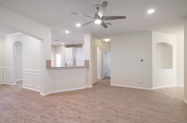 empty room featuring light hardwood / wood-style flooring, ceiling fan, and sink