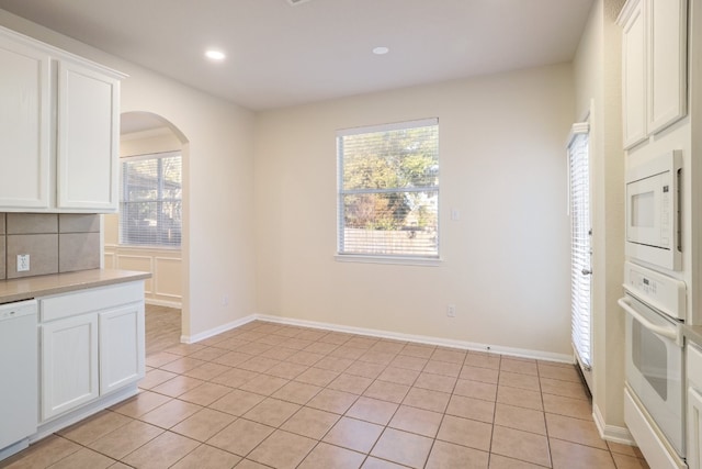 unfurnished dining area with light tile patterned flooring