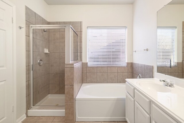 bathroom featuring vanity, tile patterned floors, and separate shower and tub