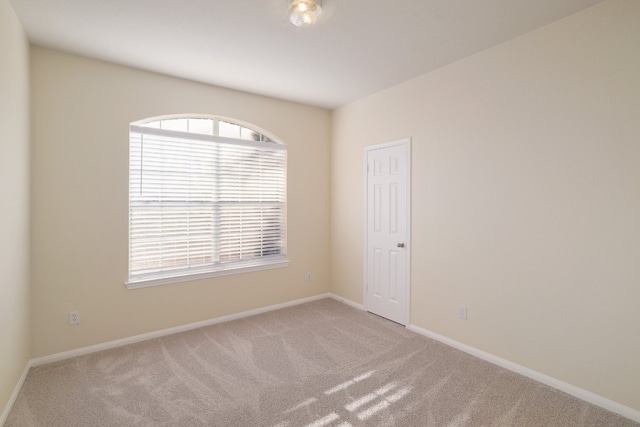 spare room with light colored carpet