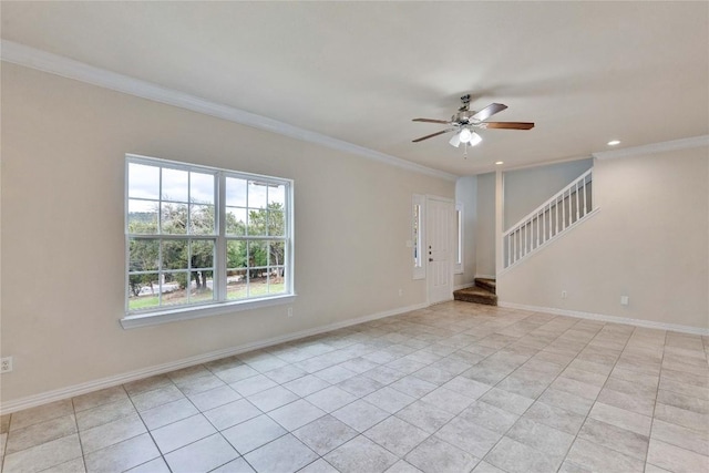 tiled empty room with ceiling fan and ornamental molding