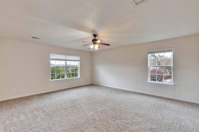 unfurnished room with ceiling fan and carpet