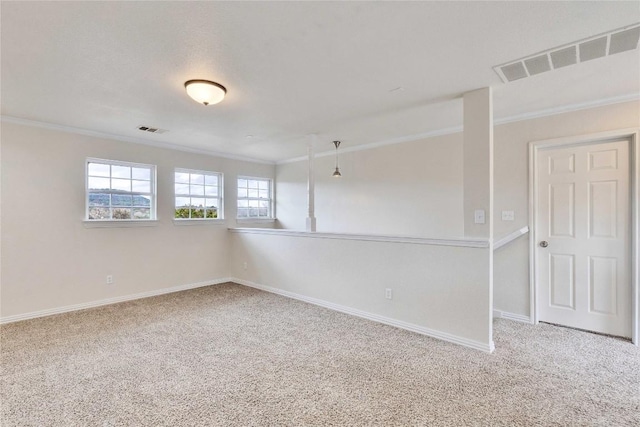 carpeted empty room featuring crown molding