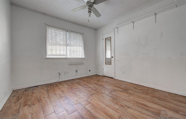 unfurnished room with ceiling fan, ornamental molding, a textured ceiling, and light hardwood / wood-style flooring