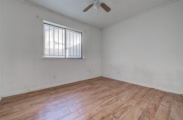 spare room featuring ceiling fan, light hardwood / wood-style floors, ornamental molding, and a textured ceiling