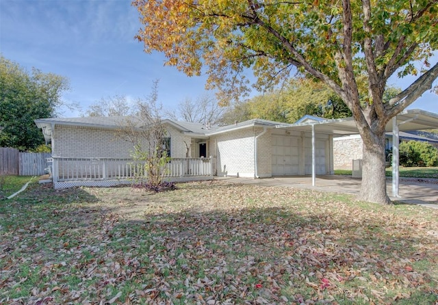 ranch-style home with a front yard, a garage, and a carport