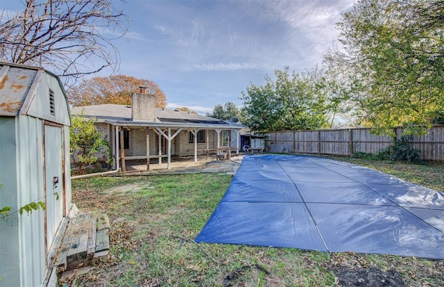 view of swimming pool with a yard and a patio