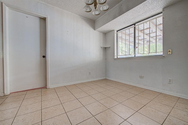 tiled spare room featuring a textured ceiling