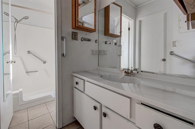 bathroom with tile patterned floors, toilet, vanity, and walk in shower