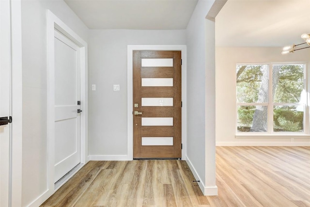 entryway featuring light hardwood / wood-style floors and a chandelier