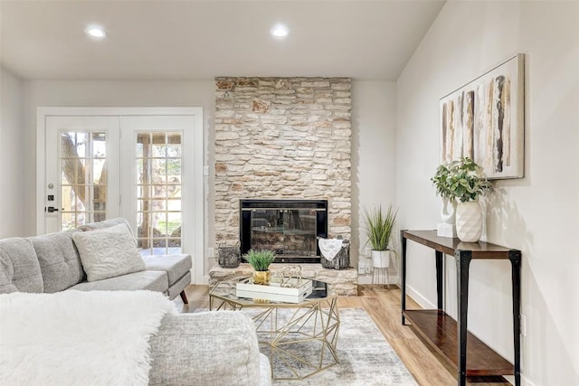 living room with light wood-type flooring and a fireplace