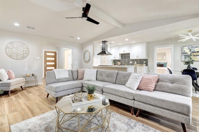 living room featuring light wood-type flooring, lofted ceiling with beams, and ceiling fan