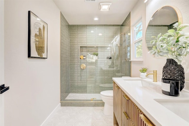 bathroom featuring tile patterned floors, vanity, toilet, and a shower with door