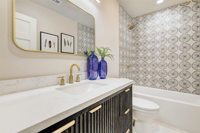 full bathroom featuring washtub / shower combination, vanity, and toilet