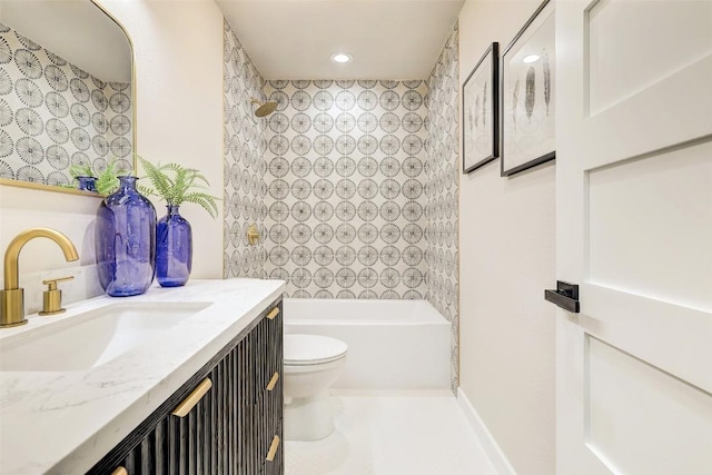 full bathroom with vanity, toilet, and tiled shower / bath