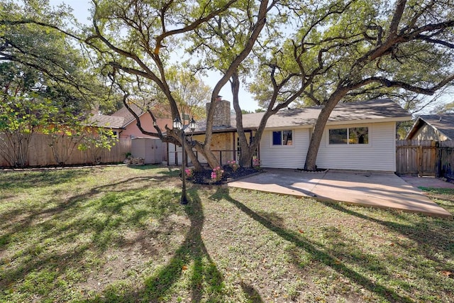 rear view of house with a yard and a patio