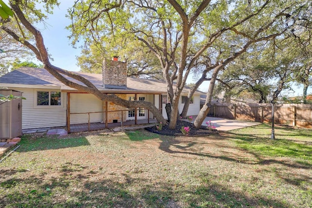 rear view of house featuring a yard and a patio