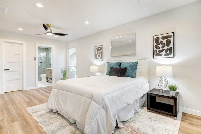 bedroom with hardwood / wood-style floors, ceiling fan, and connected bathroom