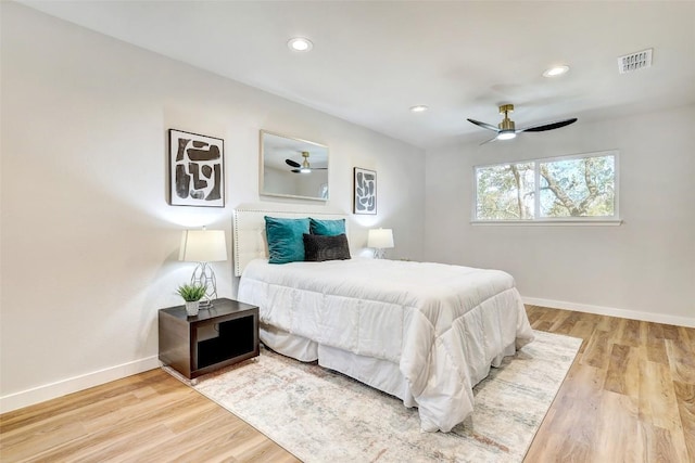 bedroom with ceiling fan and light hardwood / wood-style floors