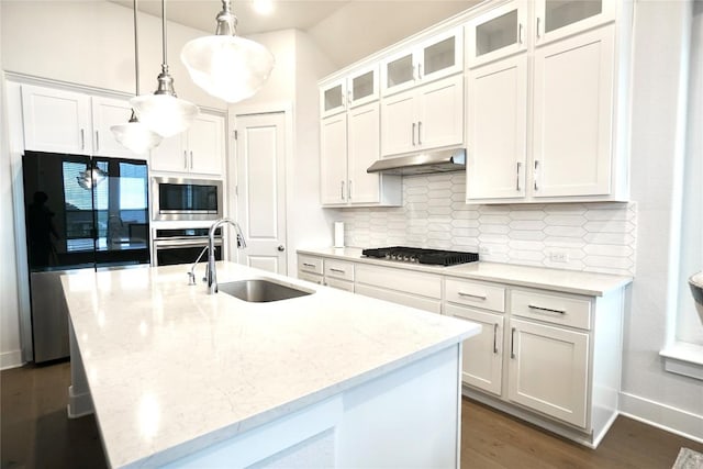 kitchen featuring white cabinetry, sink, stainless steel appliances, and light stone counters