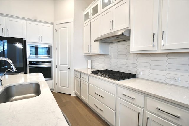 kitchen featuring stainless steel appliances, white cabinetry, dark hardwood / wood-style floors, and sink