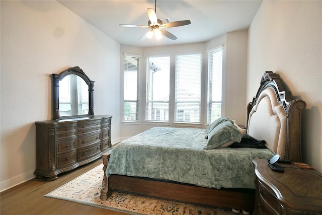 bedroom with ceiling fan and hardwood / wood-style flooring