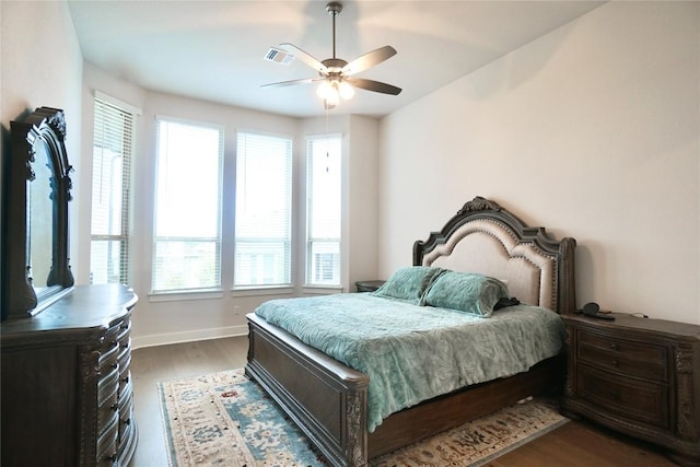 bedroom featuring ceiling fan and dark hardwood / wood-style flooring