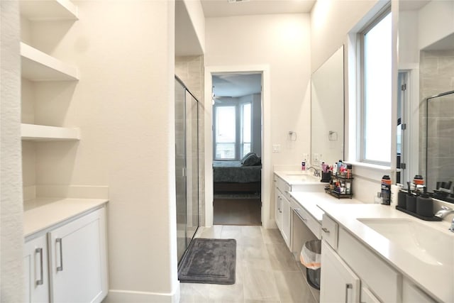 bathroom with vanity, a healthy amount of sunlight, walk in shower, and ceiling fan