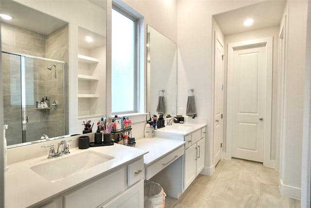 bathroom with vanity and a shower with shower door