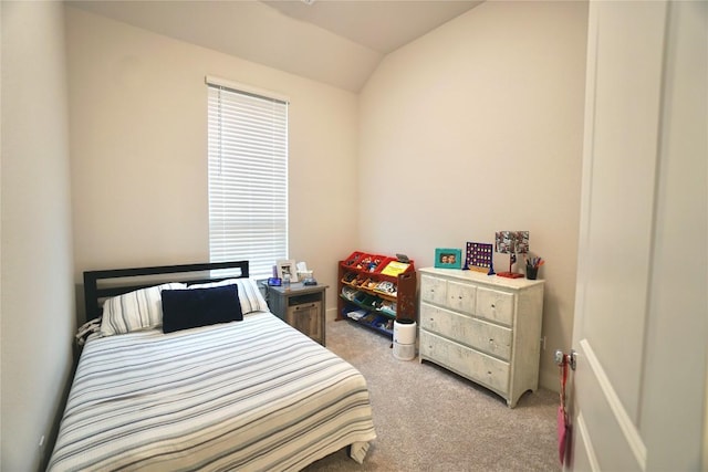 carpeted bedroom featuring lofted ceiling