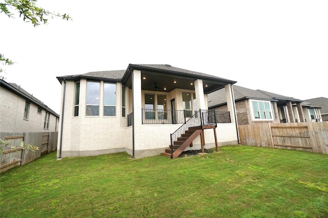 back of house featuring a lawn