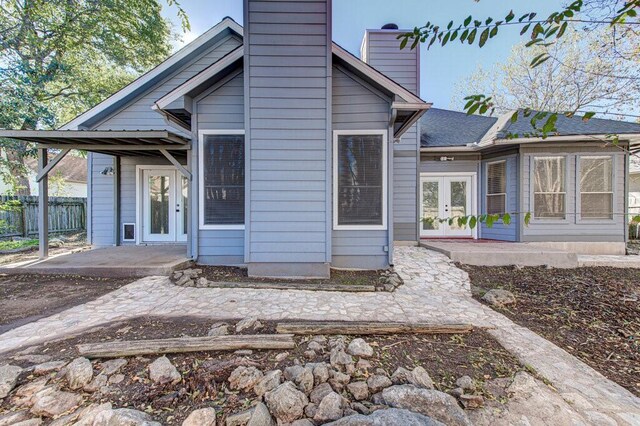 back of property with a patio area and french doors